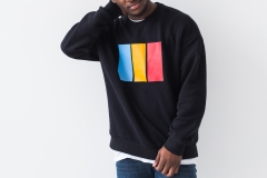 Street fashion concept - Studio shot of young handsome African man wearing sweatshirt against white background, close-up.